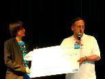 Die Schüler der 4 a Theaterklasse überreichten Pfarrer Blum den Scheck über 5.220 Euro