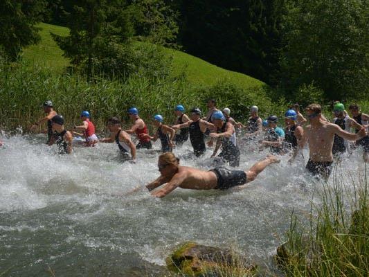Die Teilnehmer schwimmen durch den Bergsee Seewaldsee.