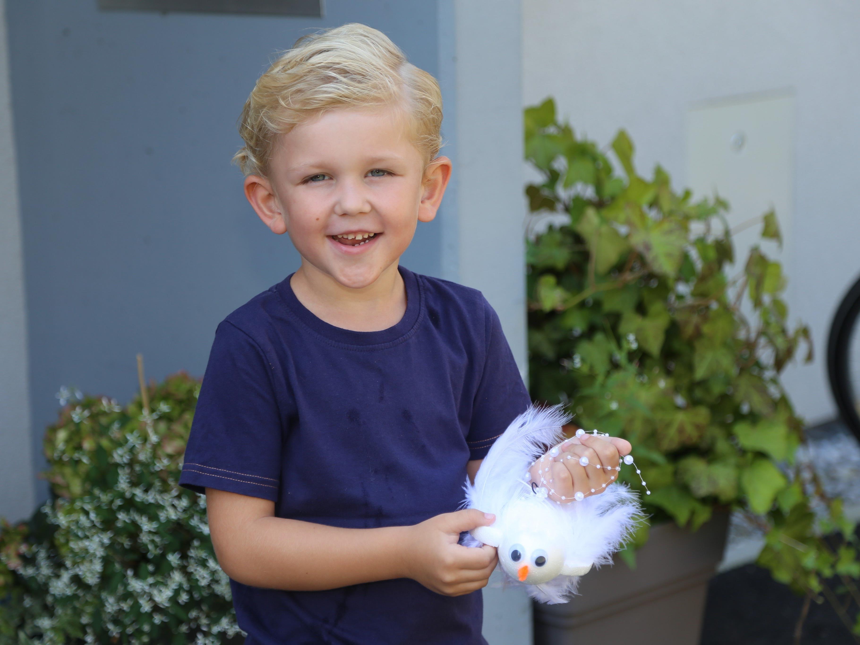 Kinderreporter Jason Durell bastelt am Weltfriedenstag eine weiße Taube.